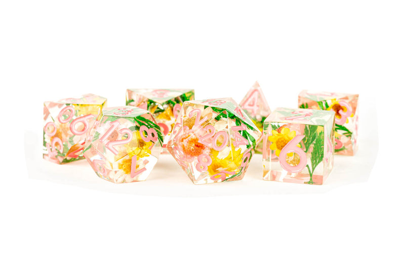 A 7 set of dice with flower inclusions and pink numbers