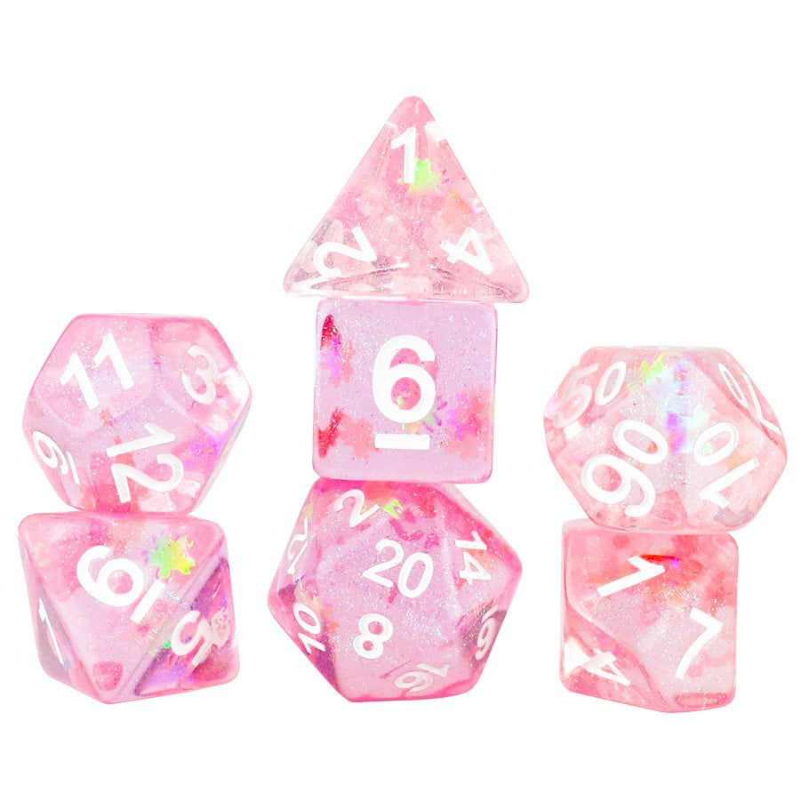 A picture of a set of 7 dice in a sparkly pink hue